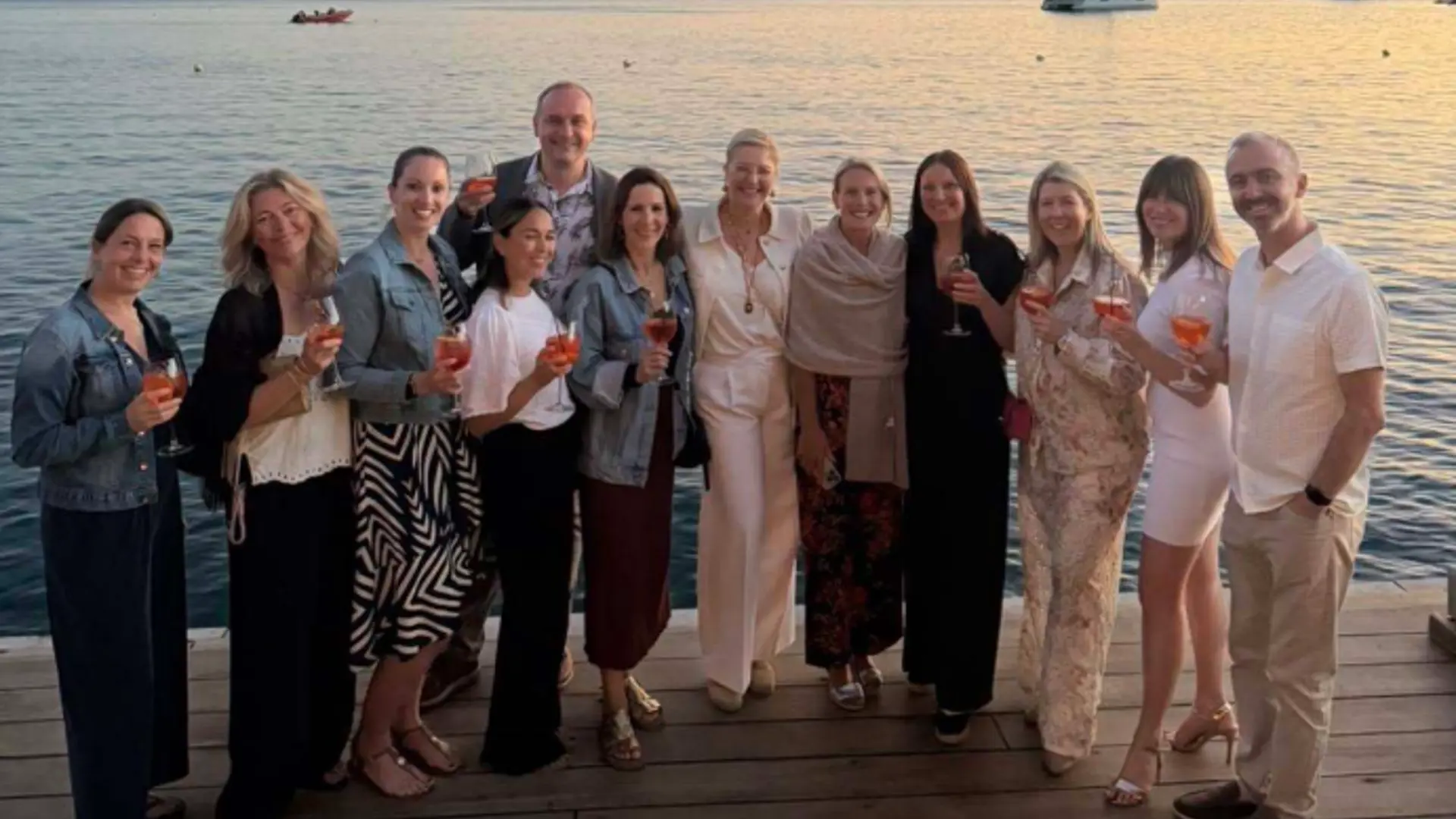 Group of Academy Travel Counsellors with sea in the background
