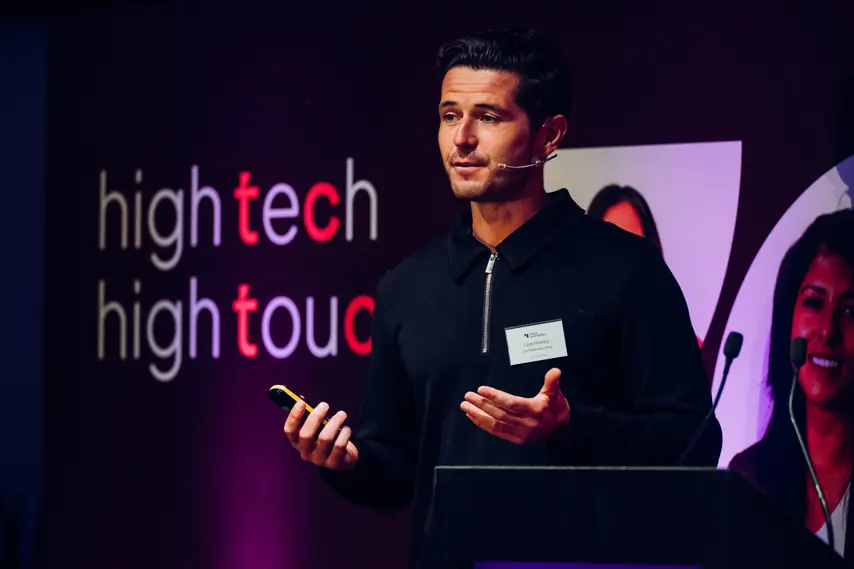 Male speaking on stage at a tech conference