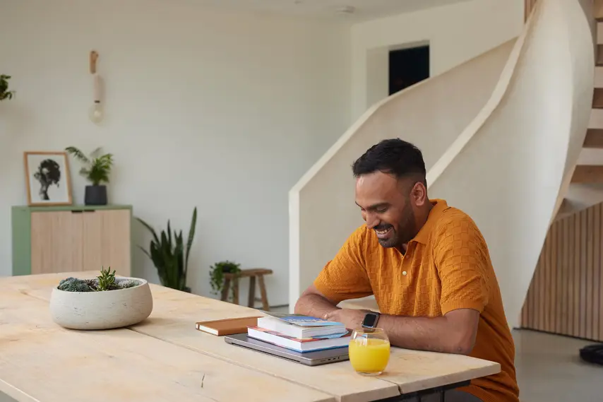 A business owner looking down at some brochures smiling